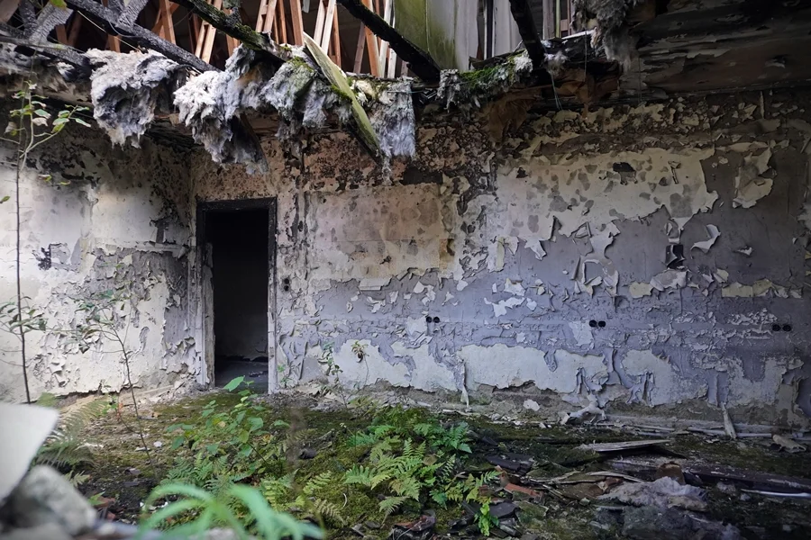 Blick durch ein zerstörtes Fenster in das Innere eines verfallenen Gebäudes auf dem ehemaligen RAF-Gelände Laarbruch.