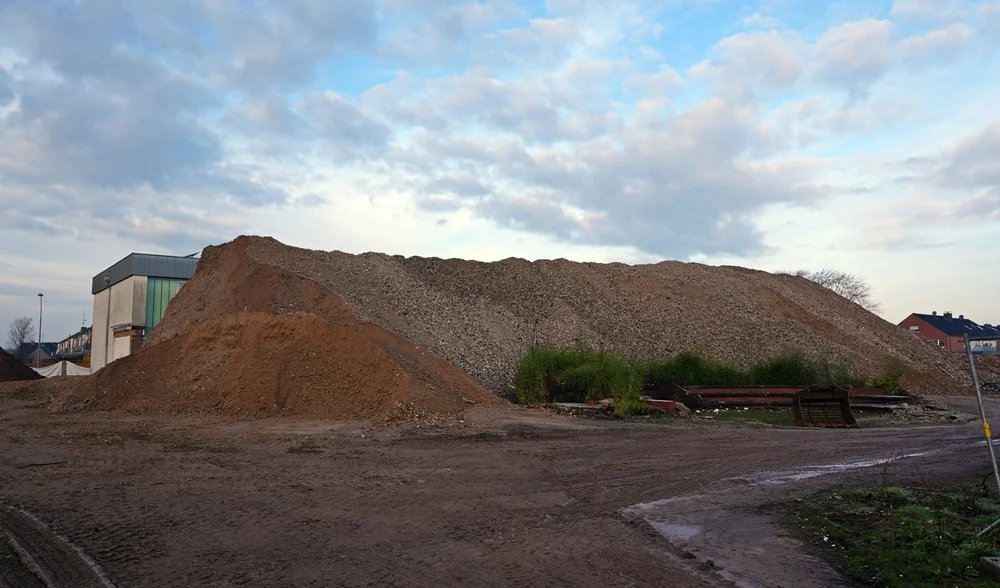 Der enorme Berg aus Beton- und Steinresten dominiert inzwischen das ehemalige Schulgelände und verdeckt fast die alte Turnhalle.